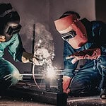 2 men welding industrial components